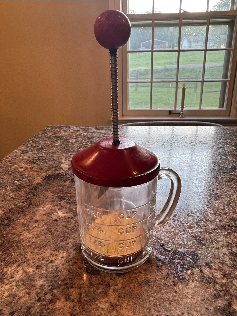 Vintage Hazel Atlas glass kitchen chopper with red lid and ball handle